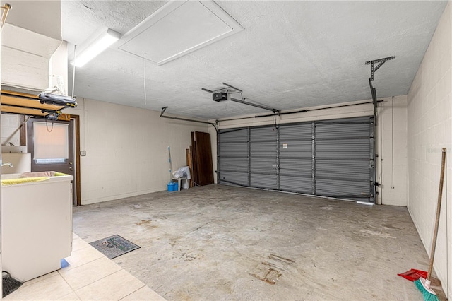 garage featuring a garage door opener and washer / dryer