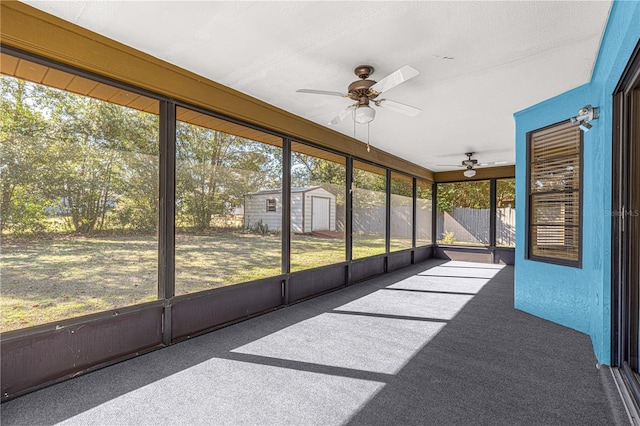 unfurnished sunroom featuring ceiling fan