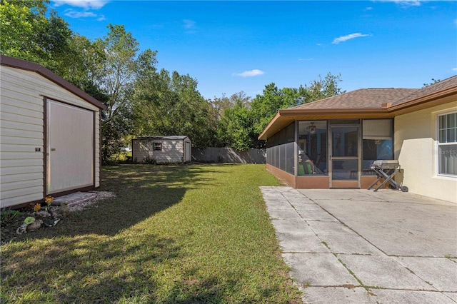 view of yard featuring a storage unit, a sunroom, and a patio area