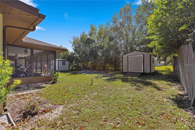 view of yard featuring a storage shed, a sunroom, and ceiling fan