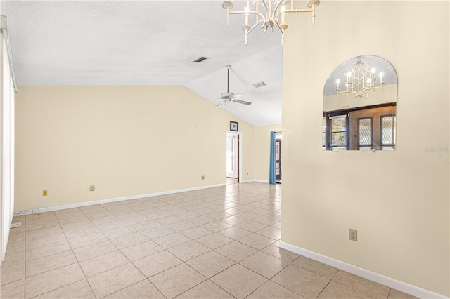 unfurnished room with ceiling fan with notable chandelier, light tile patterned flooring, vaulted ceiling, and a textured ceiling