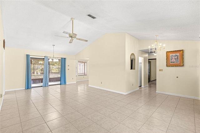 unfurnished room featuring light tile patterned floors, ceiling fan with notable chandelier, vaulted ceiling, and a textured ceiling