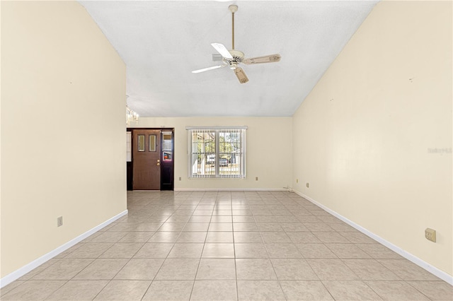 tiled empty room with vaulted ceiling and ceiling fan