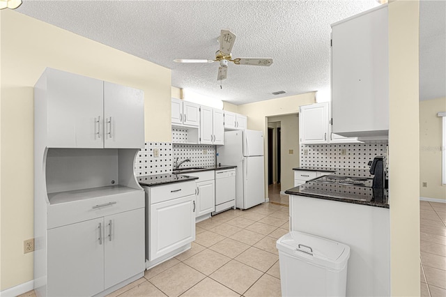 kitchen featuring white appliances, ceiling fan, backsplash, white cabinets, and light tile patterned flooring