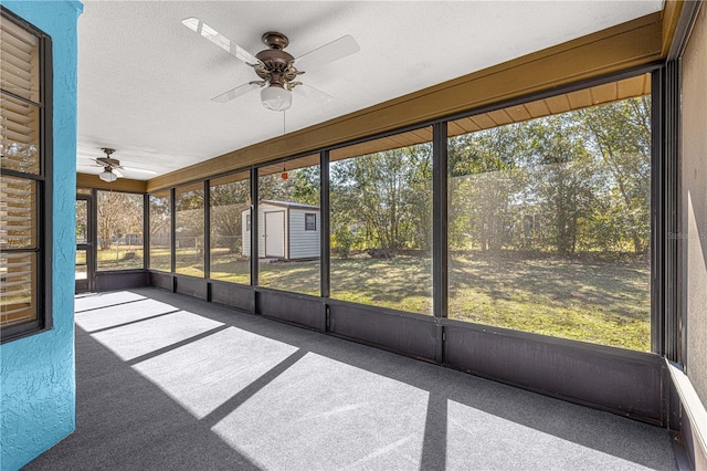 unfurnished sunroom featuring a wealth of natural light and ceiling fan