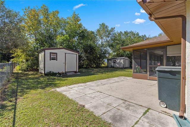 view of patio / terrace featuring a storage unit and a sunroom