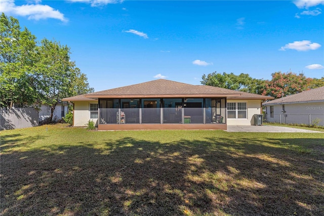 rear view of house with a patio area and a lawn