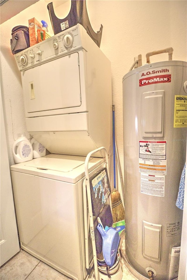 washroom featuring water heater, light tile patterned floors, and stacked washer and clothes dryer