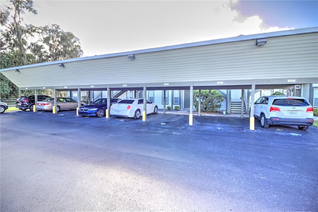 parking at dusk featuring a carport