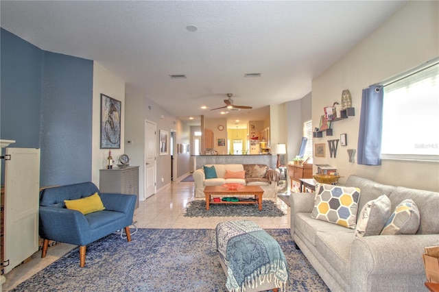 living room featuring ceiling fan and light tile patterned floors