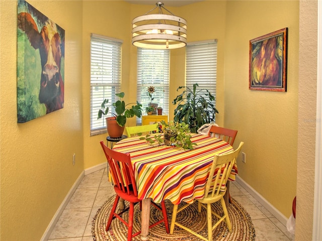 tiled dining space featuring a chandelier