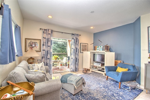 living room with a textured ceiling and light tile patterned flooring