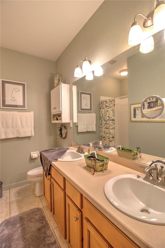 bathroom with vanity, curtained shower, tile patterned floors, and toilet