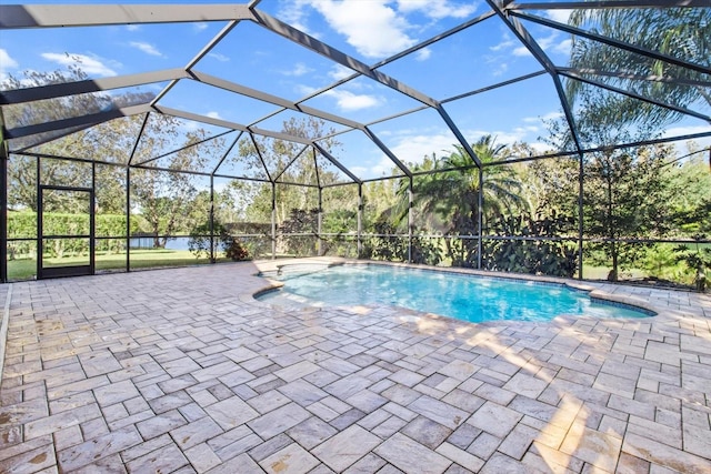 view of swimming pool featuring a patio area and glass enclosure