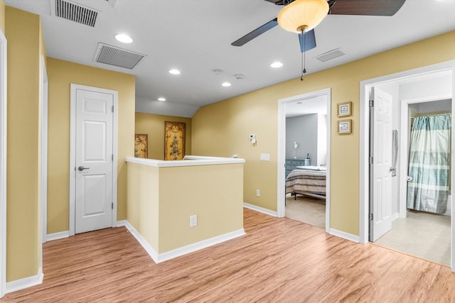 kitchen with ceiling fan and light hardwood / wood-style flooring