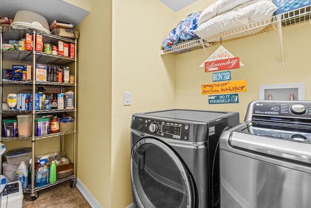 clothes washing area with independent washer and dryer and tile patterned flooring