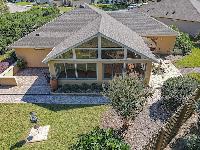 back of house featuring a yard and a sunroom