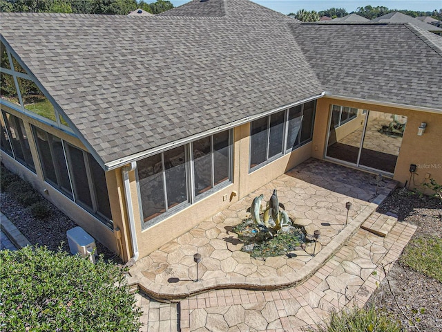 back of house featuring a sunroom and a patio area