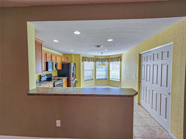 kitchen featuring sink, black appliances, decorative light fixtures, and kitchen peninsula