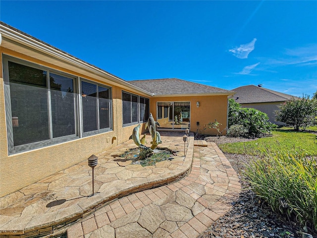 rear view of property featuring a patio