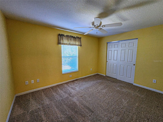 unfurnished bedroom with a closet, a textured ceiling, carpet flooring, and ceiling fan