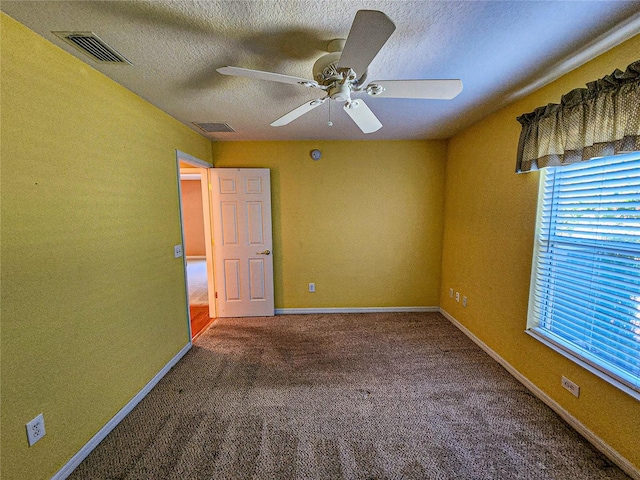 empty room featuring carpet, a textured ceiling, and ceiling fan