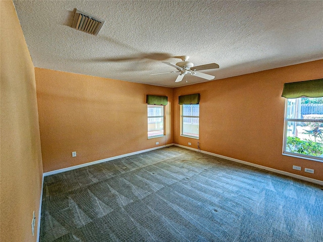 carpeted empty room with a textured ceiling and ceiling fan