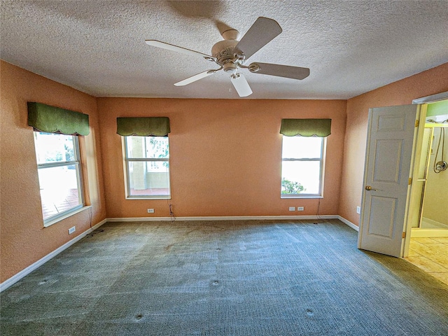 carpeted empty room with a textured ceiling and ceiling fan