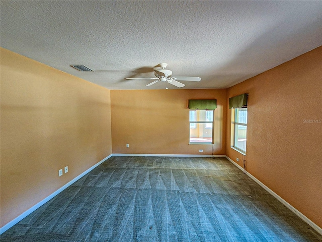 spare room with ceiling fan, a textured ceiling, and carpet floors