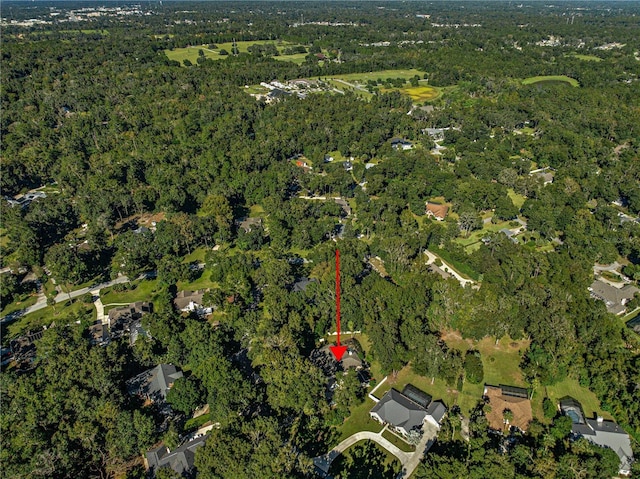 birds eye view of property with a view of trees