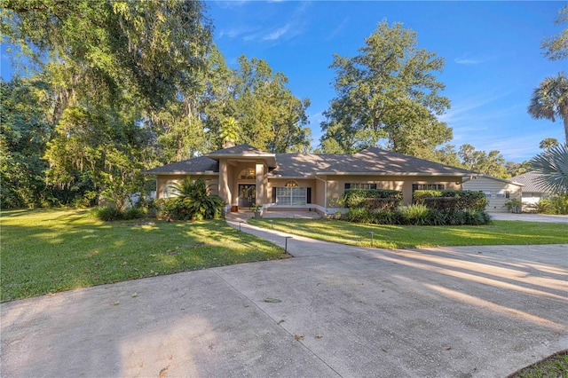 view of front of house with a front yard and stucco siding