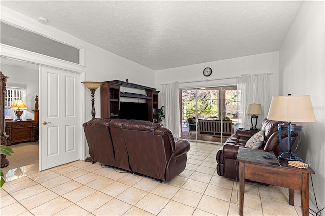 living room with light tile patterned floors and a textured ceiling