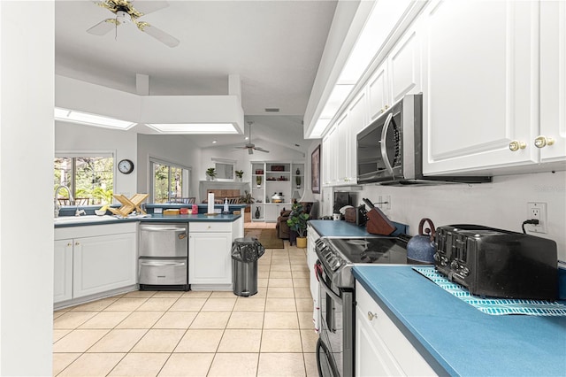 kitchen with white cabinets, a sink, light tile patterned flooring, a ceiling fan, and appliances with stainless steel finishes