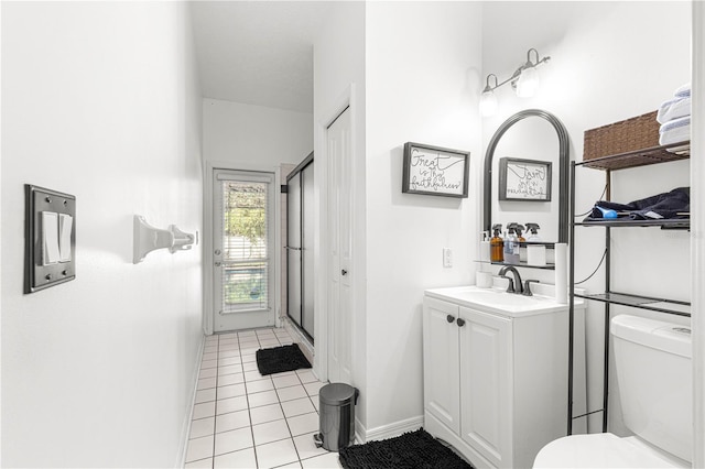 full bath featuring tile patterned floors, a shower with door, vanity, baseboards, and toilet
