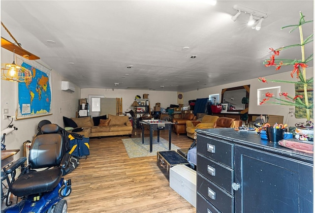interior space featuring light wood-type flooring and a wall unit AC