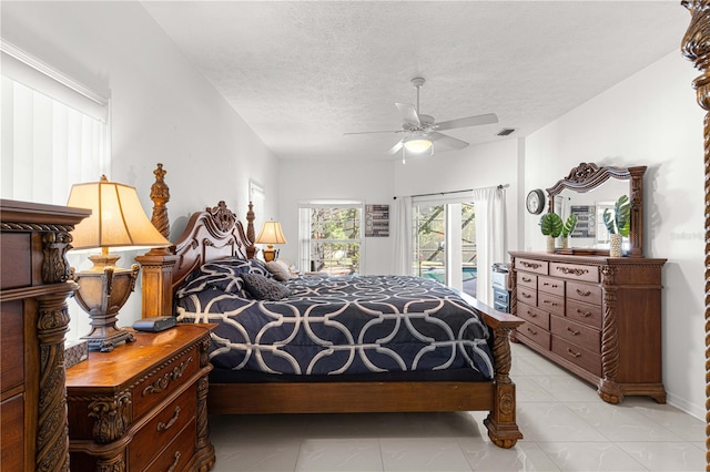 bedroom with a textured ceiling, access to outside, and ceiling fan