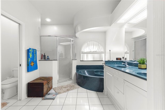 full bathroom with tile patterned floors, vanity, toilet, and plus walk in shower