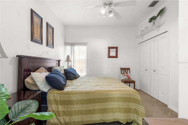 bedroom with ceiling fan, a closet, and light colored carpet