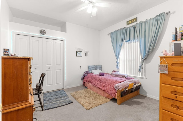 bedroom featuring ceiling fan, light carpet, and a closet