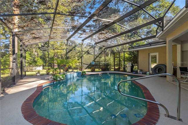 view of swimming pool with glass enclosure and a patio area