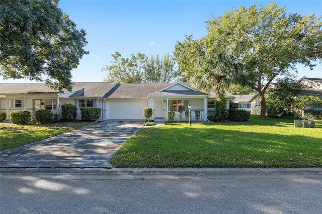 ranch-style home featuring a front lawn and a garage