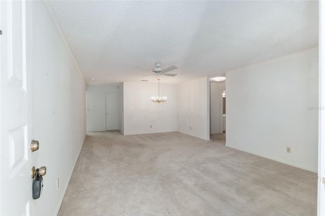 spare room featuring ceiling fan, a textured ceiling, and light colored carpet