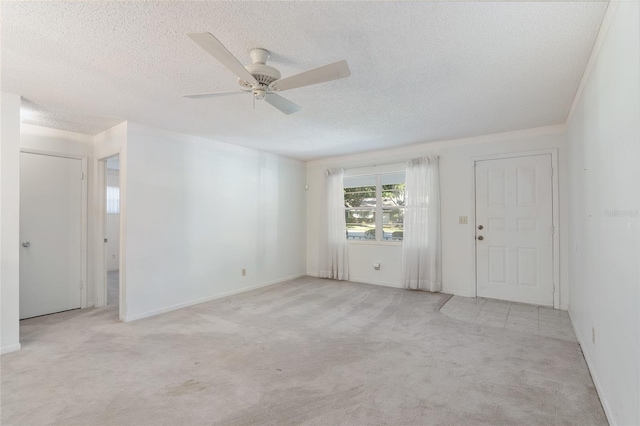 carpeted empty room with a textured ceiling and ceiling fan