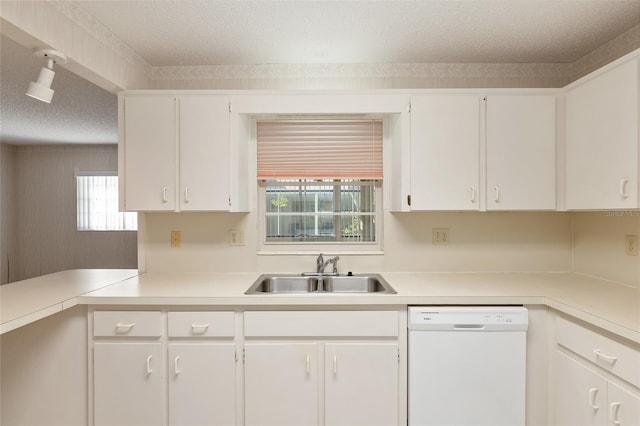 kitchen with sink, a healthy amount of sunlight, dishwasher, and white cabinets