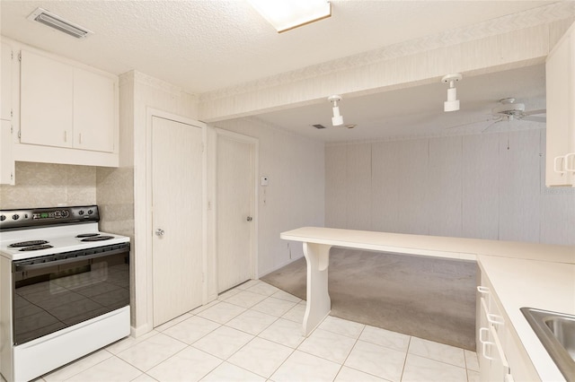 kitchen featuring tasteful backsplash, ceiling fan, light tile patterned floors, white cabinetry, and white electric range oven