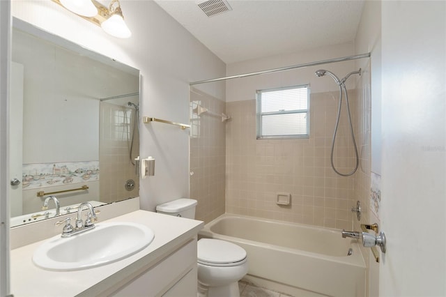 full bathroom with vanity, toilet, tiled shower / bath combo, and a textured ceiling