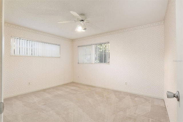 unfurnished room with light colored carpet and ceiling fan