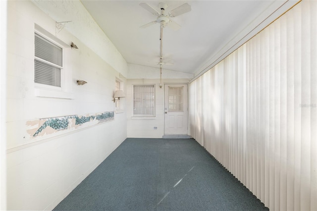 interior space featuring dark carpet and lofted ceiling