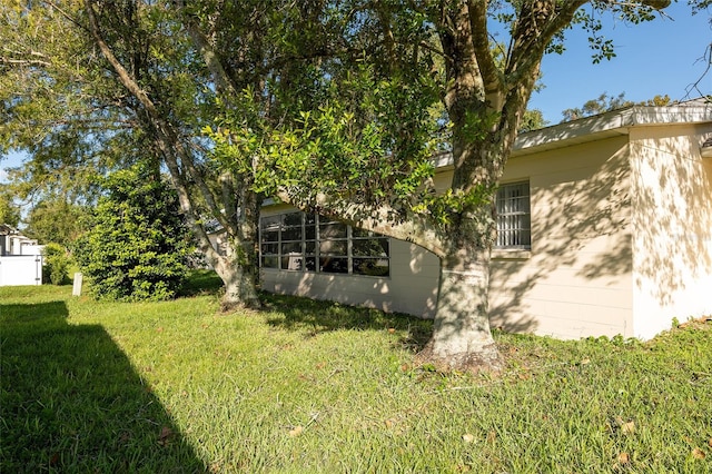 view of side of home with a lawn