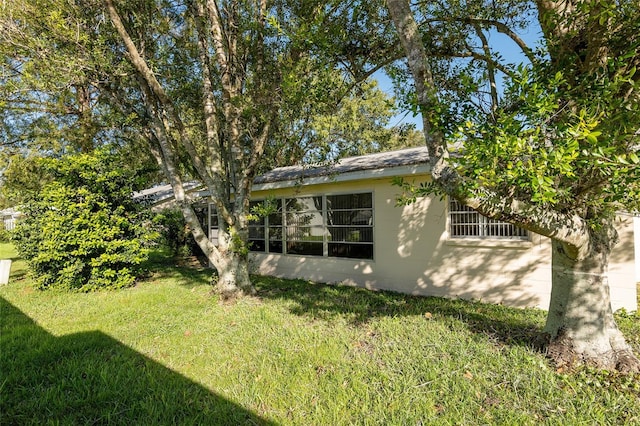 view of home's exterior with a lawn